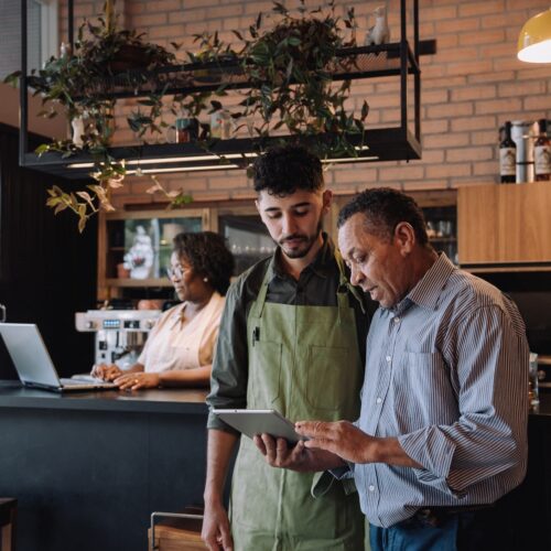 Coffee shop owner talking to employee